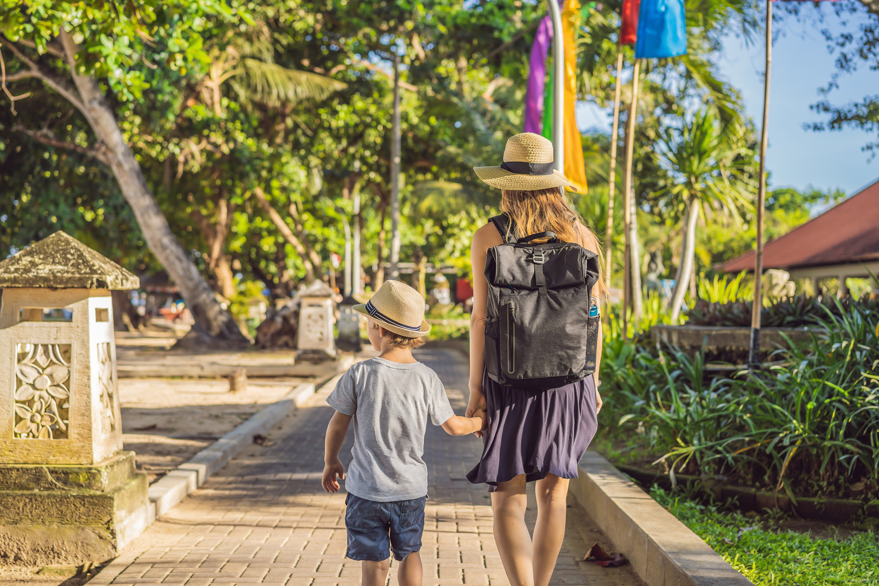Mom and son travelers discovering Sanur, Bali Indonesia. Traveling with children concept